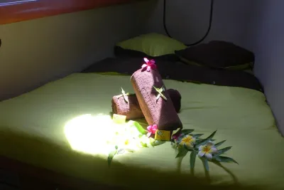 Double cabin on Aqua Tiki II — double bed with flowers laid on the cover