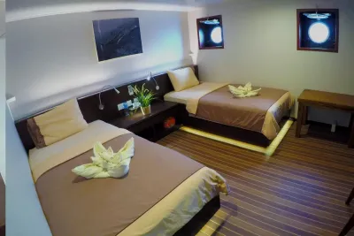 Lower deck cabin — two single beds and round portholes