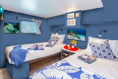 Deluxe stateroom on Cayman Aggressor IV with two single beds and a porthole