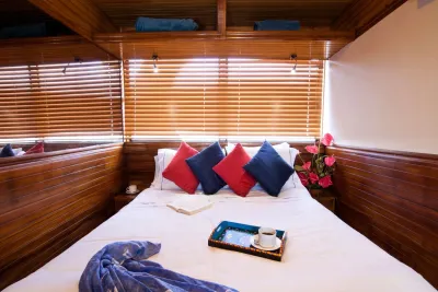 Master Stateroom on Galapagos Aggressor III — double bed and wooden blinds