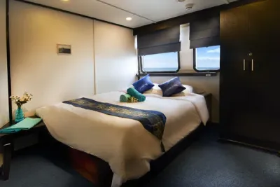 Premium Double cabin on the middle deck of Galapagos Master with a double bed by the window