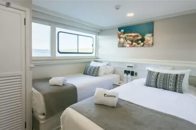 Master Stateroom on Galapagos Sky — two single beds and a picture window