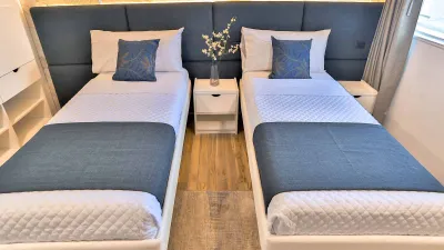 Lower deck twin cabin on Galaxy Diver II — two beds and a bedside table