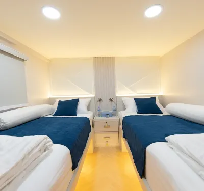 Cabin B3 on Krishna 3 — two beds, a bedside table and windows on both sides
