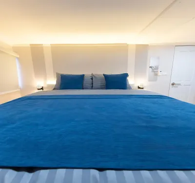 Master cabin V1 on Krishna 3 — a wide bed under a backlit headboard