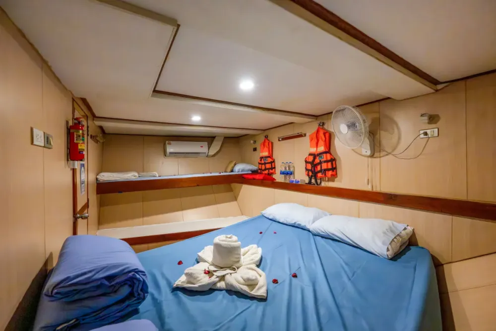 Double cabin on the lower deck of Manta Queen 2 — wide bed and air conditioning
