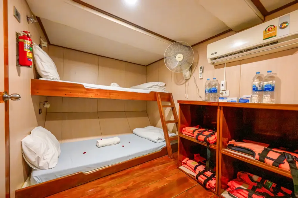 Twin cabin on Manta Queen 2 with bunk beds and life jacket shelving