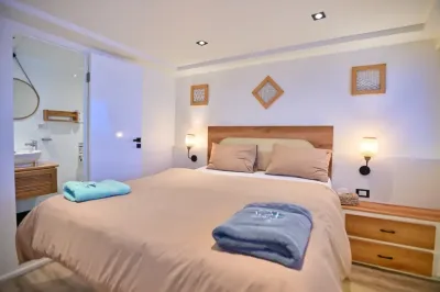 Sun-deck suite on Ocean Lovers — double bed and the doorway to the bathroom