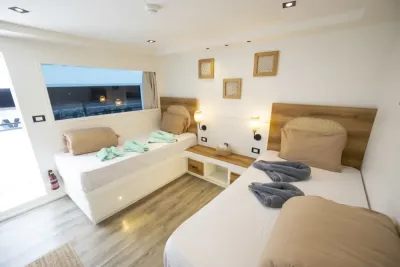 Twin cabin on the sun deck of Ocean Lovers — separate beds beside a panoramic window