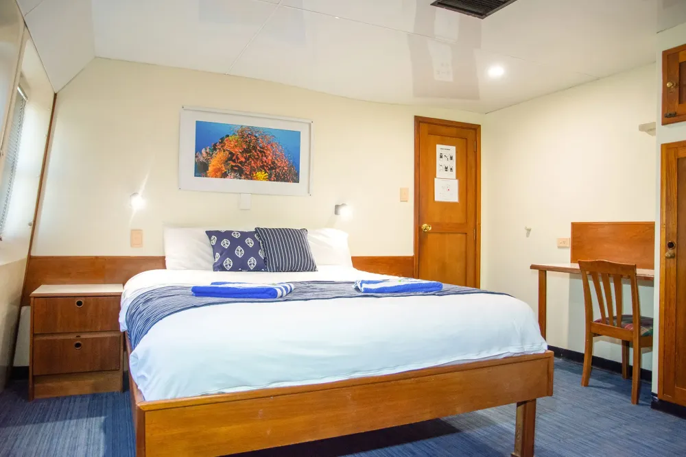 Ocean Quest double cabin with a double bed and writing desk