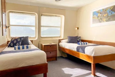 Twin cabin on Ocean Quest with two single beds beside the windows
