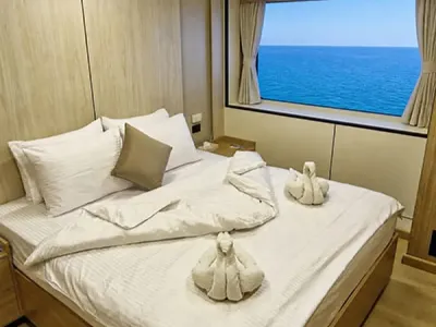 Double cabin on Odyssey — double bed beside a panoramic window