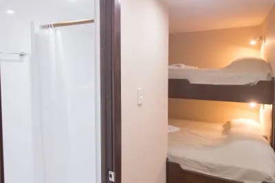 Deluxe stateroom on Okeanos Aggressor II — bunk beds and the shower entrance