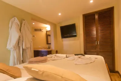 Master Deluxe stateroom on Okeanos Aggressor II — queen bed, bathrobes and television