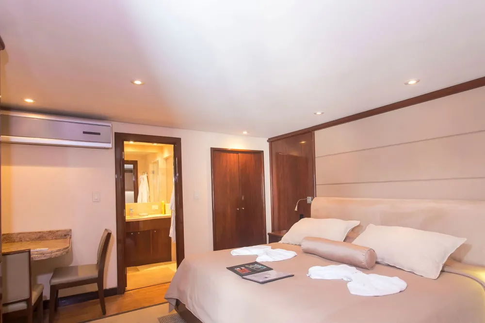 Suite No. 11 on Okeanos Aggressor II — king-size bed and the bathroom entrance