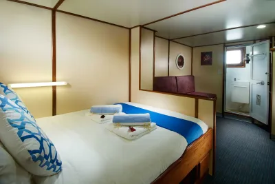 Premium Twin/Double cabin on Pacific Master — double bed and the door to the en-suite bathroom