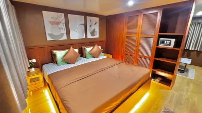 Raga master suite with a king bed and wood panelling