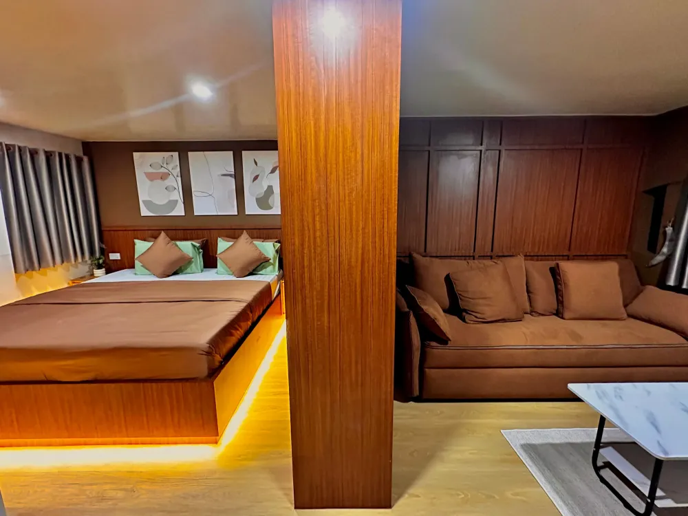 Raga master suite — sleeping area and sofa behind a partition