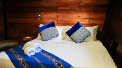 Lower-deck double cabin — bed beneath niches holding brassware