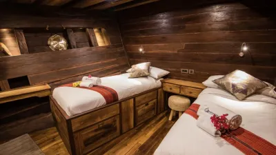Cabin with two single beds along the sides and red runners
