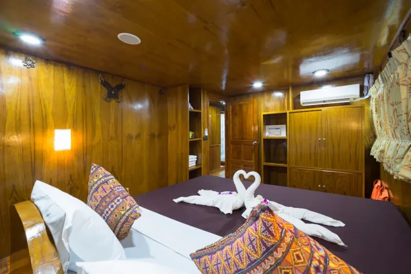 Master cabin interior — Thai wood finish and air conditioning