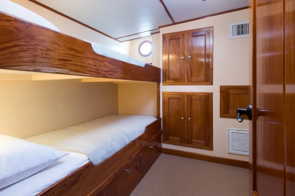 Two single berths one above the other in a lower deck cabin