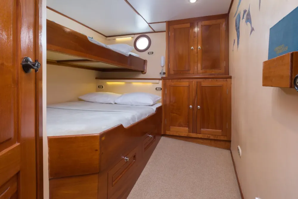 Double bed and wardrobe in a lower deck cabin on Sea Hunter