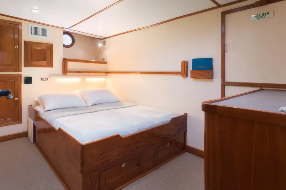 Porthole and headboard lighting in a lower deck cabin