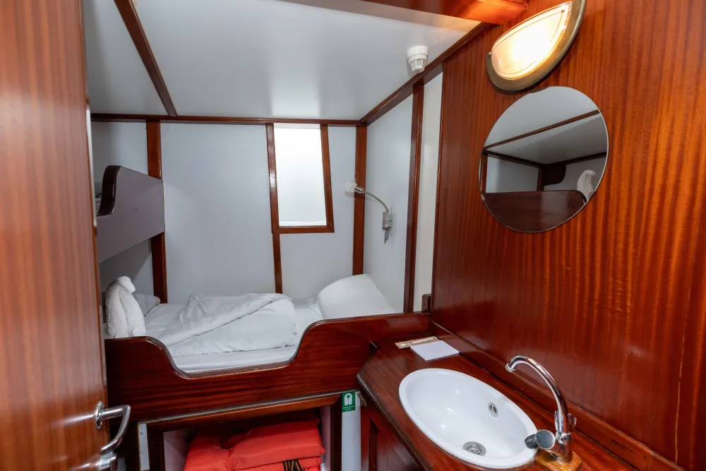 Category B cabin on Sea Pearl, porthole, mirror and timber finish