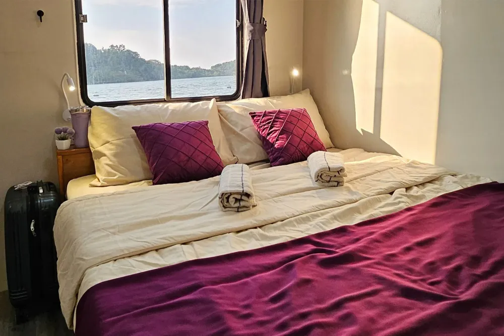 Main deck cabin on Seatopia with room for a suitcase and a sea view