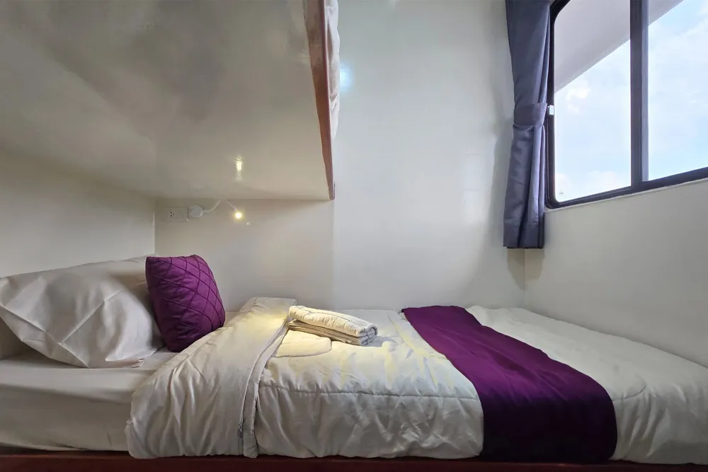 Lower berth of a bunk cabin beside the panoramic window