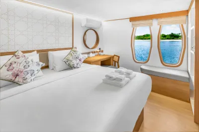 Cabin 201 on the main deck of Solitude Gaia — king-size bed by the portholes