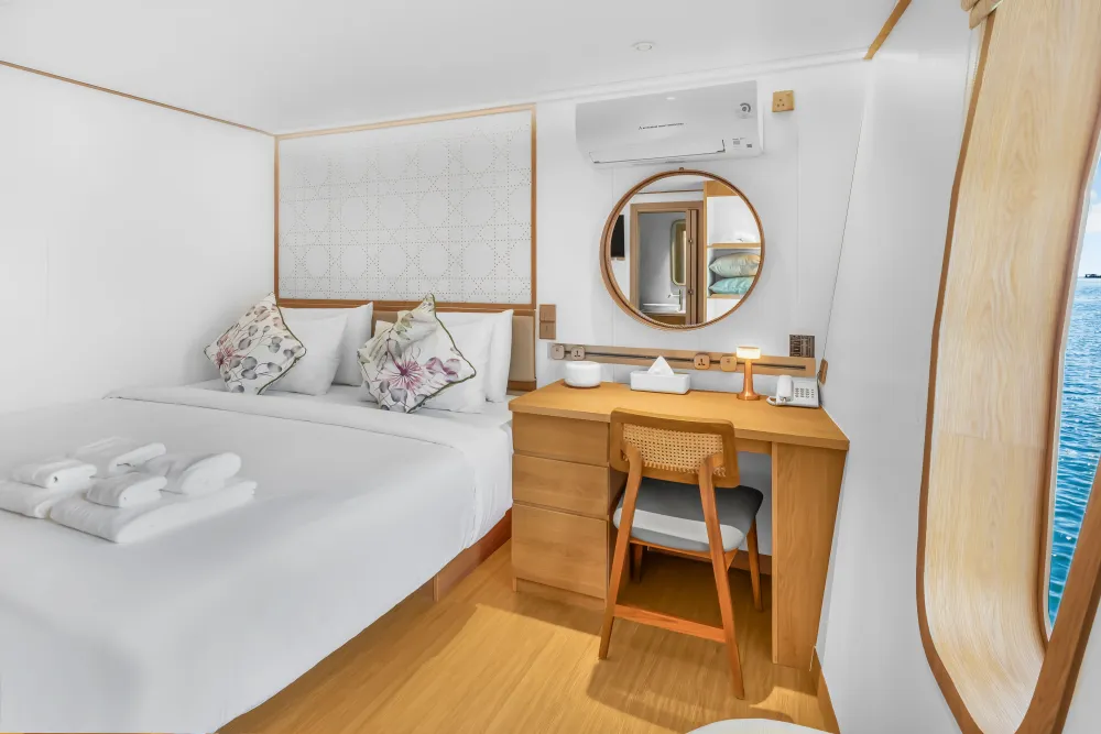 Main deck cabin on Solitude Gaia — dressing table and round mirror