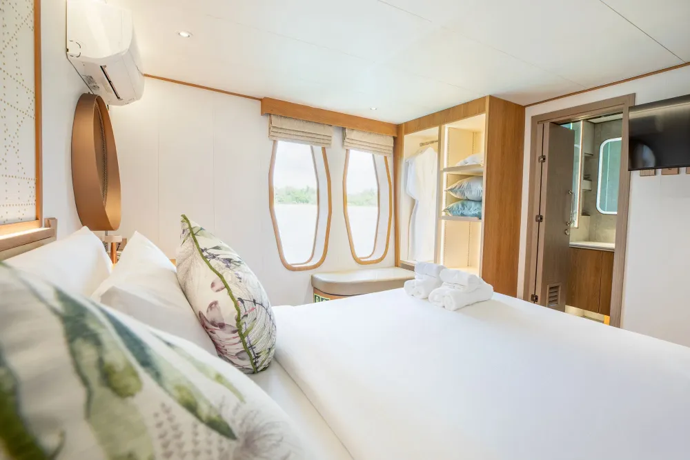 Cabin 202 on Solitude Gaia — view from the bed towards the portholes and bathroom