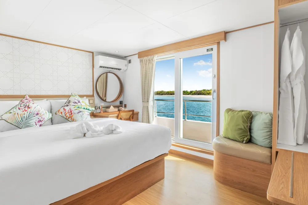 Cabin 303 on the upper deck of Solitude Gaia — king-size bed and deck access