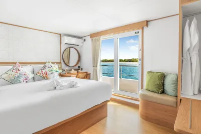Cabin 303 on the upper deck of Solitude Gaia — king-size bed and deck access