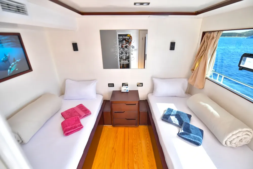 Comfort cabin on the upper deck of South Moon 1 — two beds and a large window