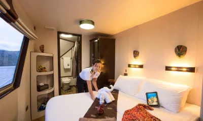 Master stateroom on the main deck of Thailand Aggressor — queen bed and bathroom door