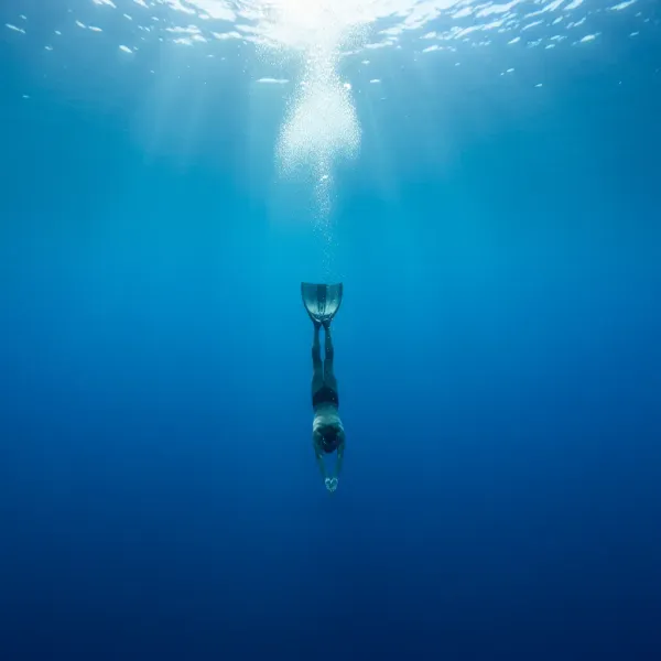 A freediver descending into the deep