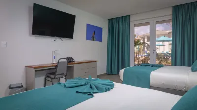 A room with two beds and a TV