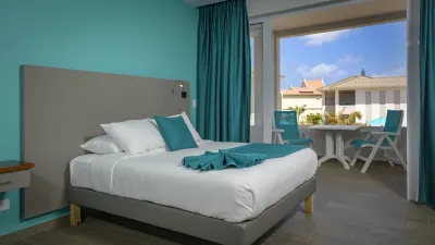 A bed by the window in one of the new rooms