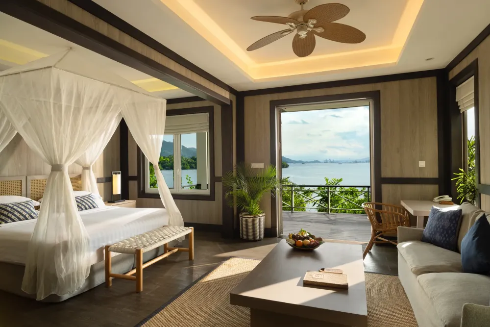 Cottage bedroom with a canopy bed and ocean view