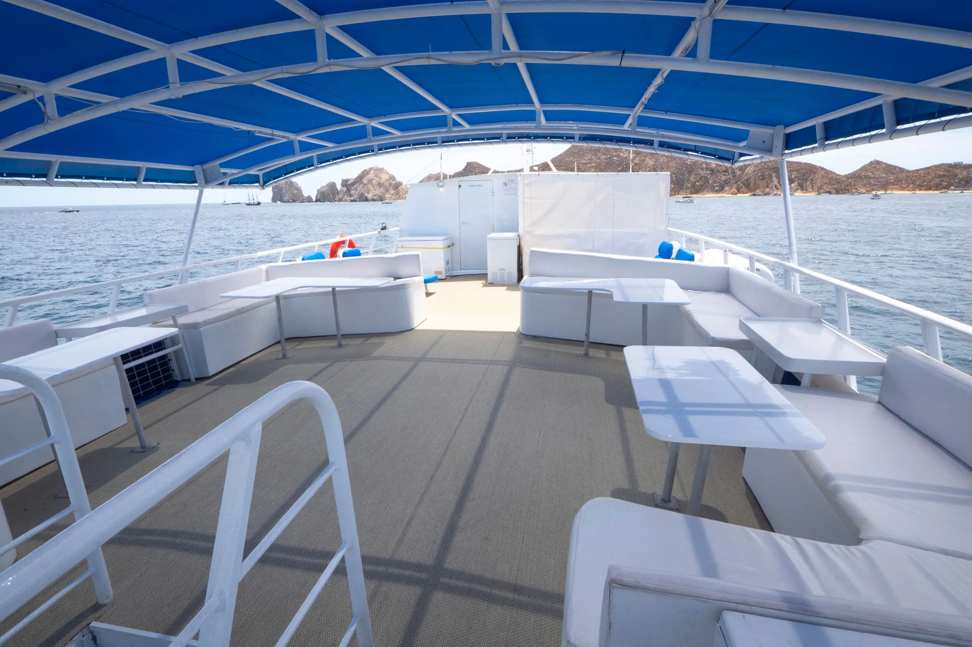 Shaded upper deck of Adventure furnished with cushioned seating