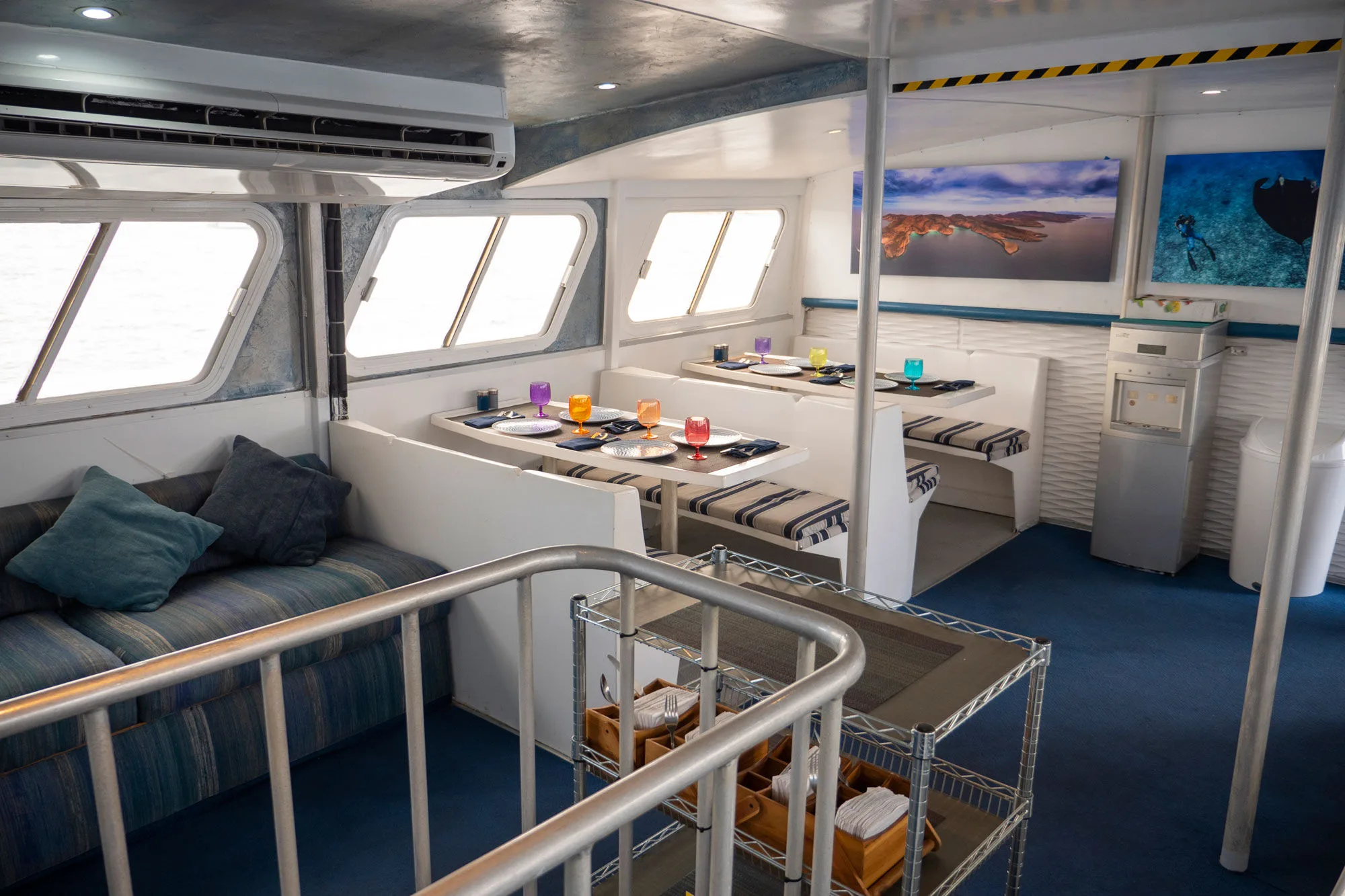 Lounge aboard Adventure with a corner sofa and wide windows
