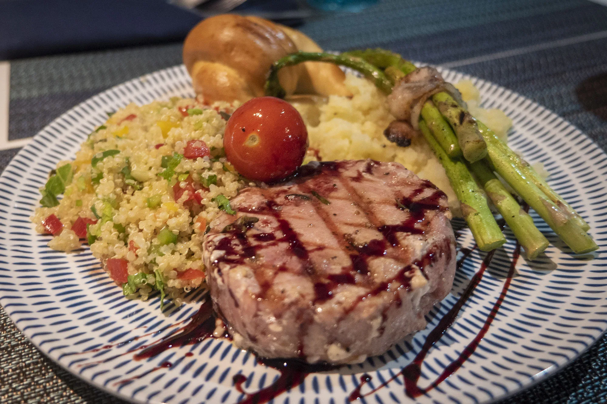 Dinner aboard Adventure, a grilled tuna steak served with sides