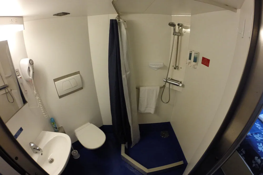 En-suite bathroom on the All Star Aqua Cat with shower, basin and hairdryer