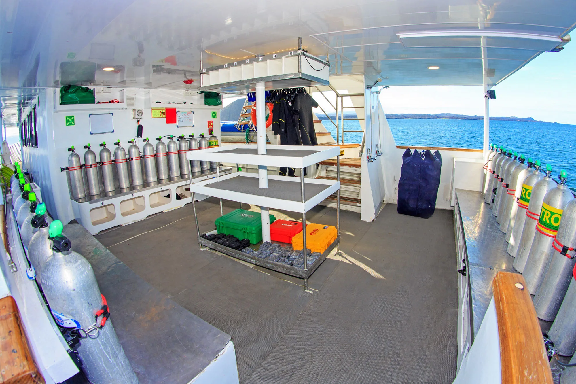Dive deck of Aqua with tanks racked along the sides