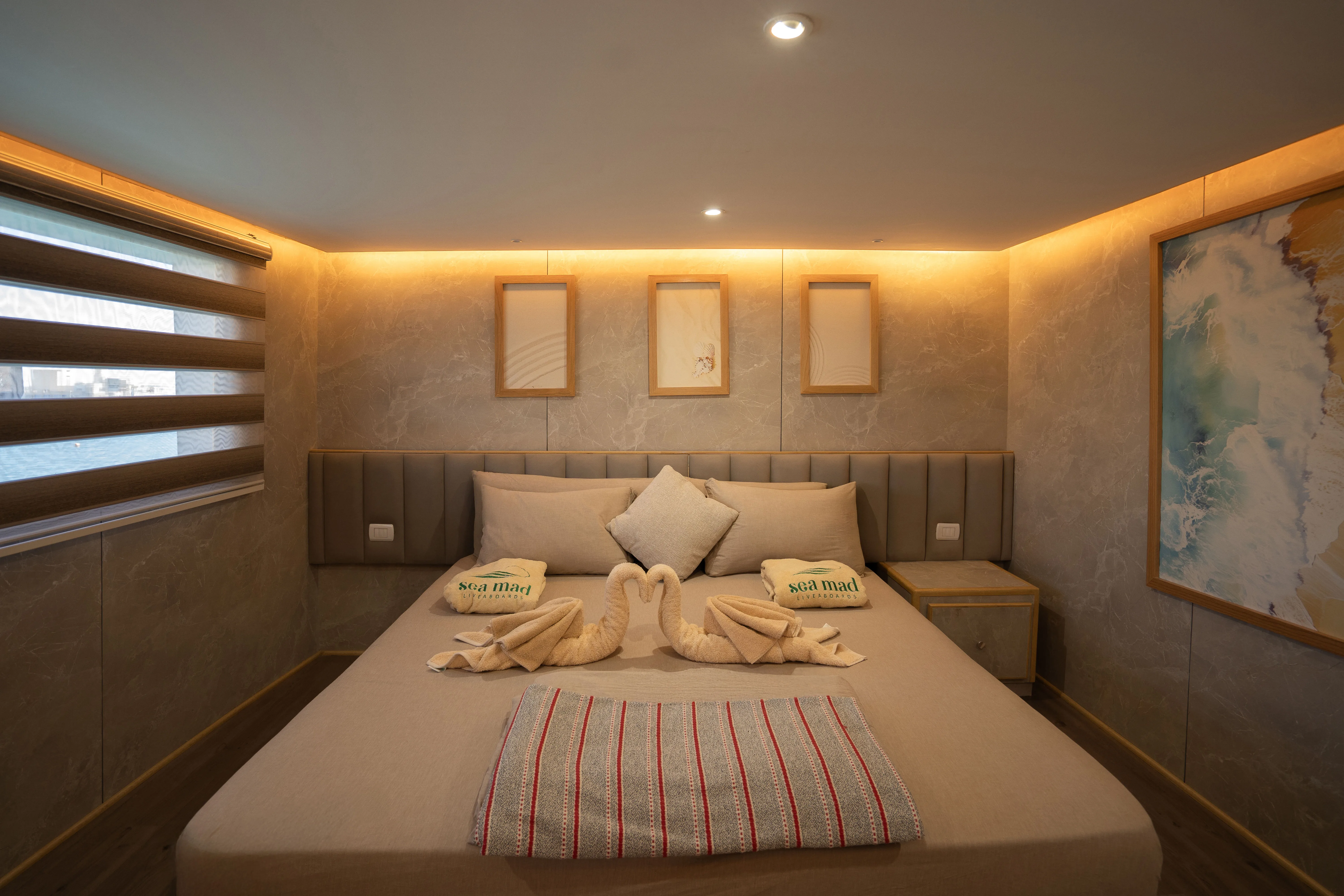 Double bed in a premium cabin on Avo with cove lighting