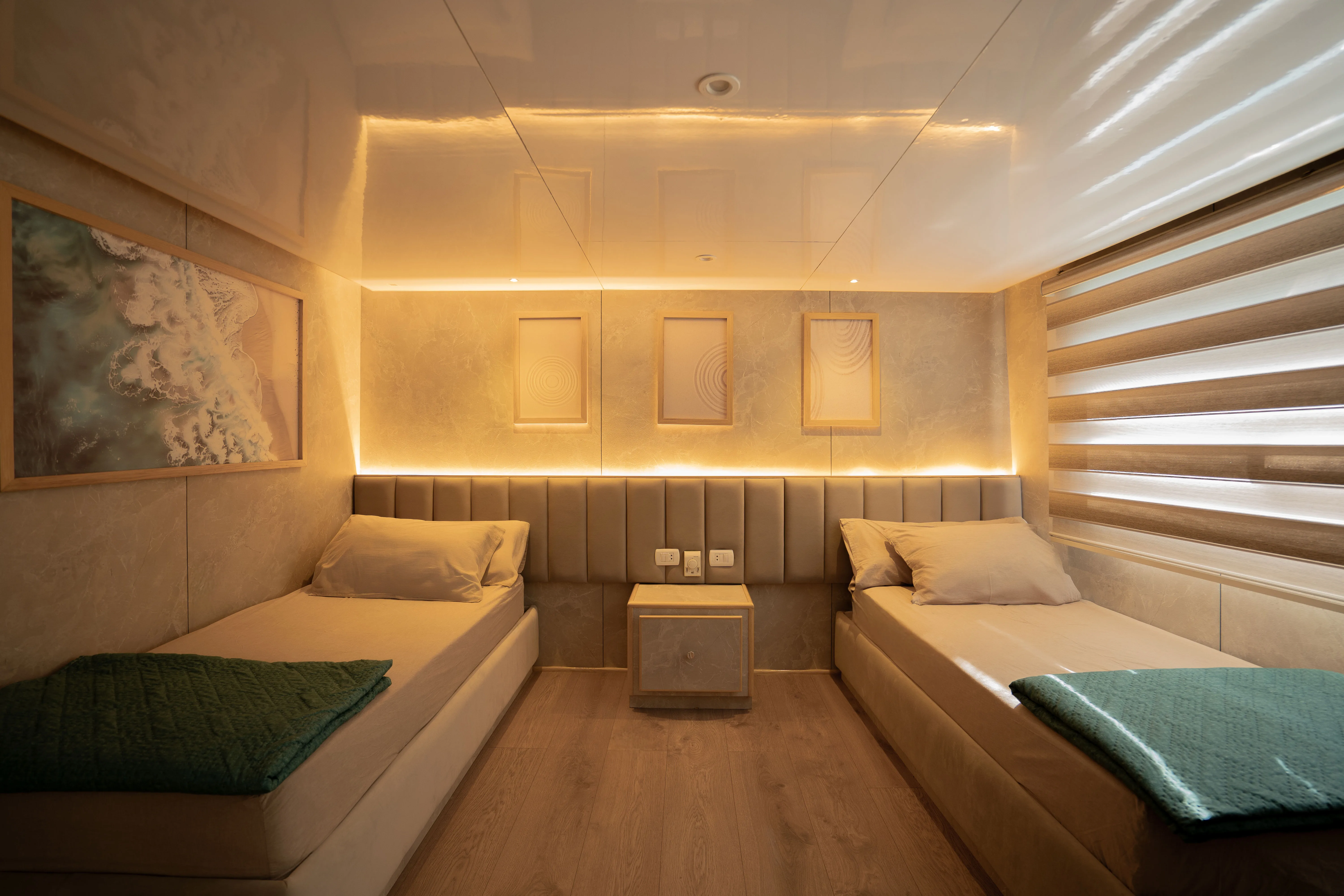 Premium cabin on Avo — lighting above the headboards and a full-width window