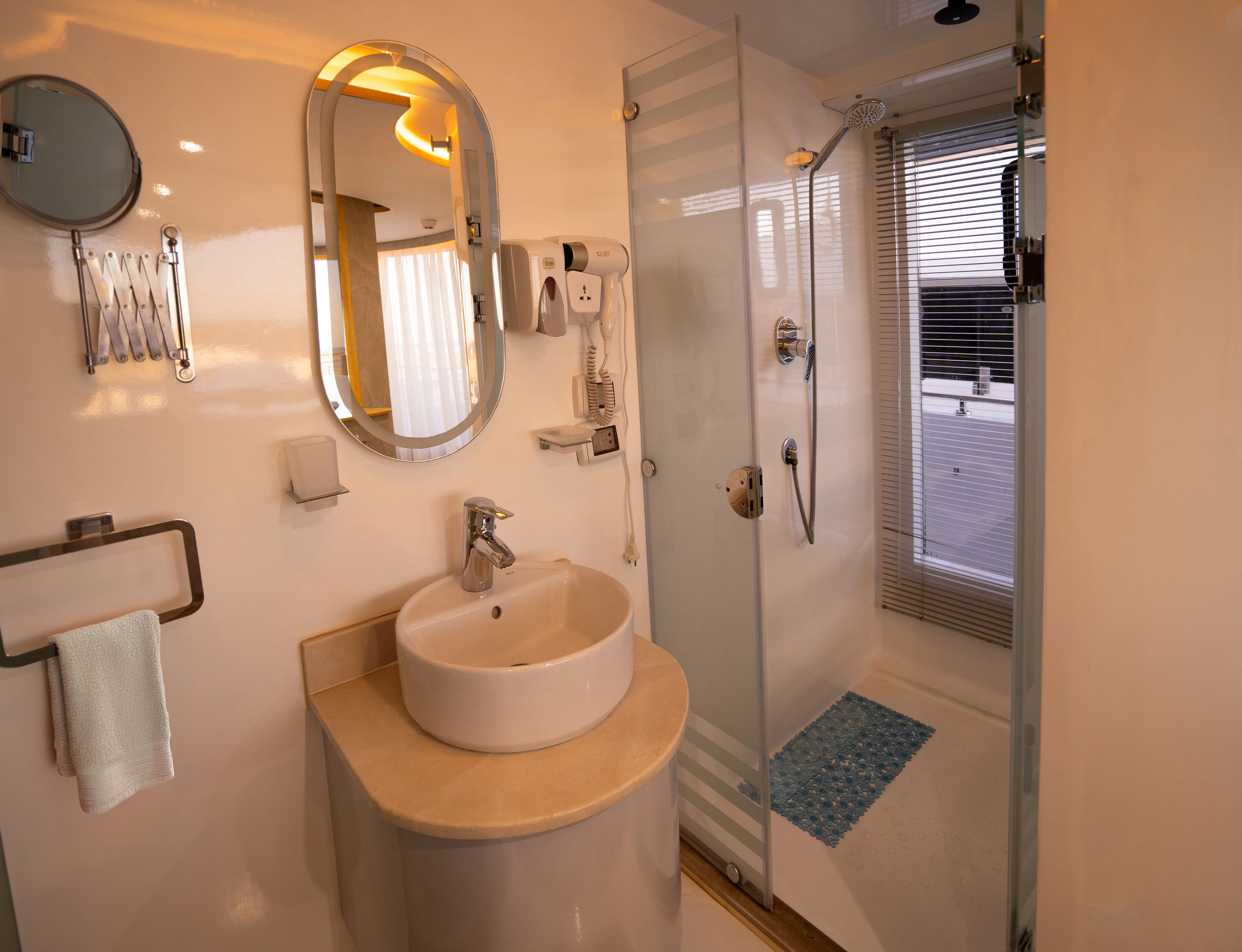 En-suite bathroom of an Avo suite — shower, basin and mirror